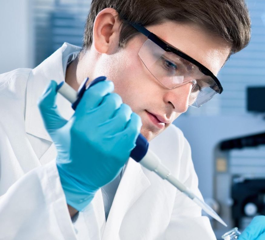 Laboratory technician using a micropipette to accurately measure and transfer liquids in a lab setting